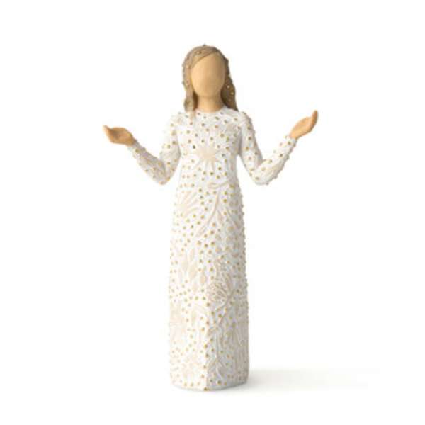 Decorative angel figurine in a white patterned dress with raised arms