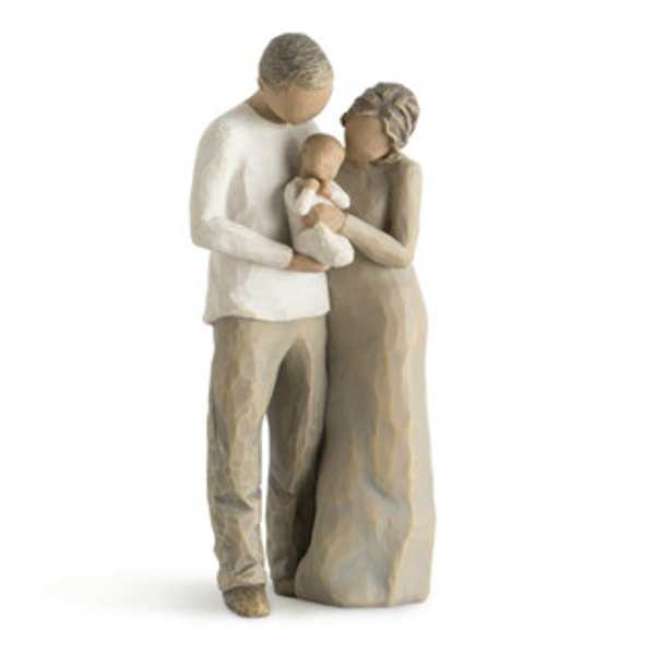 Wooden figurine of a couple holding a baby