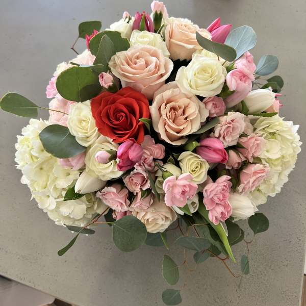Bouquet of roses, tulips, and hydrangeas in pink, white, and red