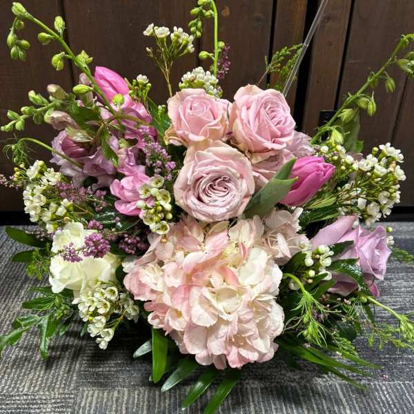 Pink and white floral arrangement with roses and hydrangea