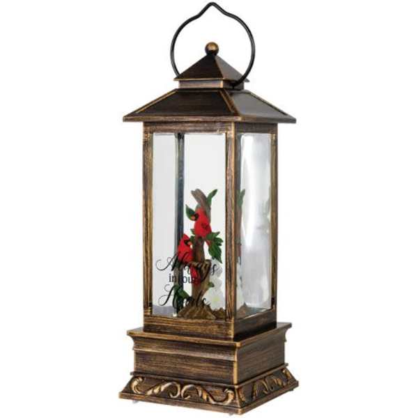 Decorative lantern with a small floral arrangement inside