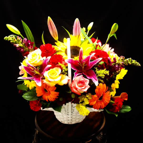 Colorful mixed flower basket with roses, lilies, sunflowers, and gerbera daisies