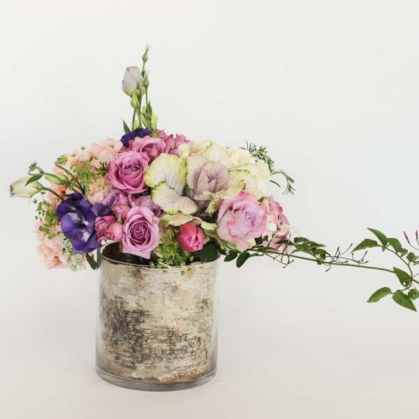 Mixed pink and purple bouquet in a glass vase