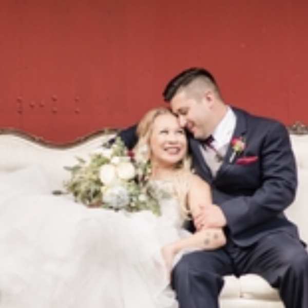 Bride and groom seated with a white bridal bouquet