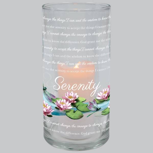 Glass candle holder with a lit candle and pink water lily design
