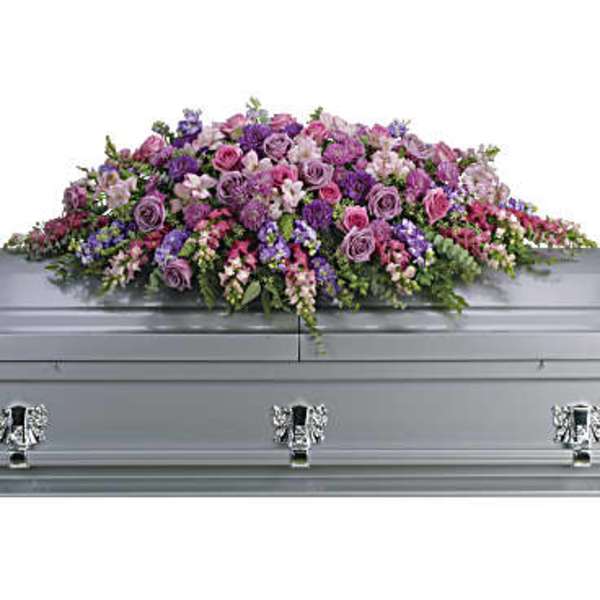 Large pink and purple floral spray on a silver casket