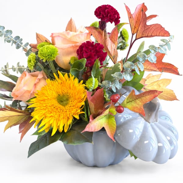Fall bouquet in a blue pumpkin-shaped vase with roses and chrysanthemums