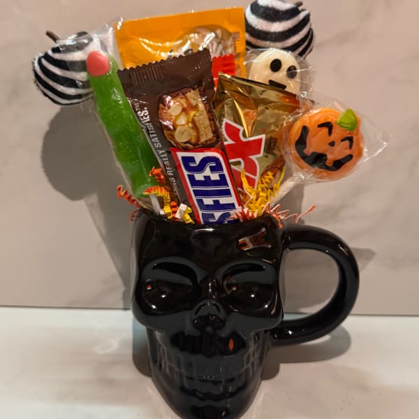 Halloween candy bouquet in a black skull mug
