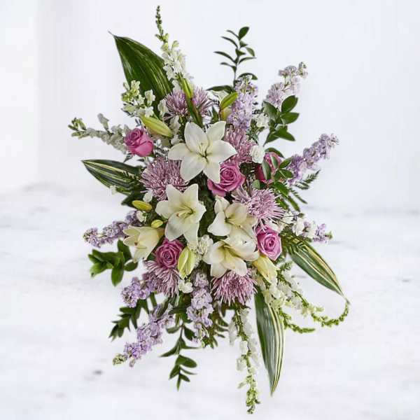 Bouquet of white lilies, pink roses, and lavender flowers