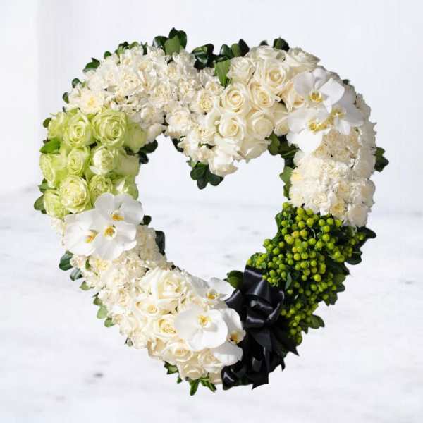 Heart-shaped floral wreath with white roses and orchids