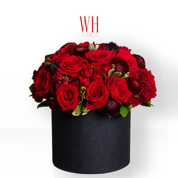 Red roses arranged in a black round box