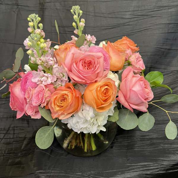 Pink and orange rose bouquet in a glass vase