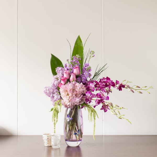 Pink and purple floral arrangement in a glass vase
