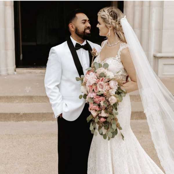 Bride and groom with a cascading pink bouquet