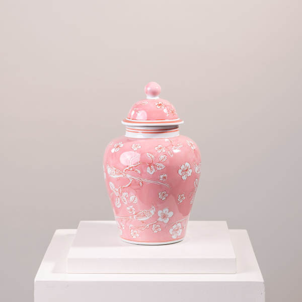 Pink ceramic lidded jar with white floral and bird pattern