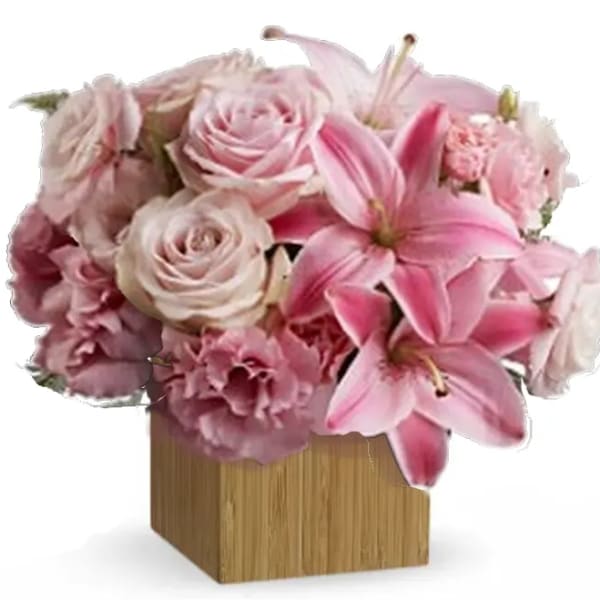 Pink roses and lilies arranged in a square wooden vase