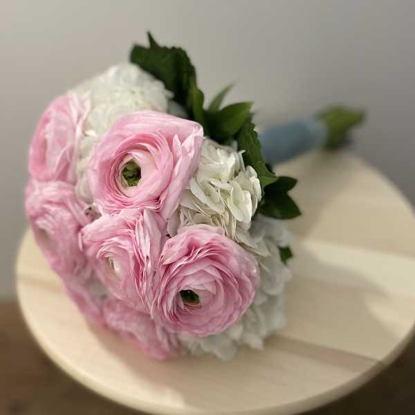 Bouquet of pink and white flowers with green leaves
