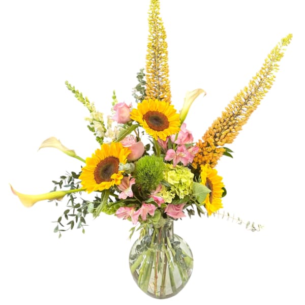 Sunflowers, pink blooms, and calla lilies in a glass vase