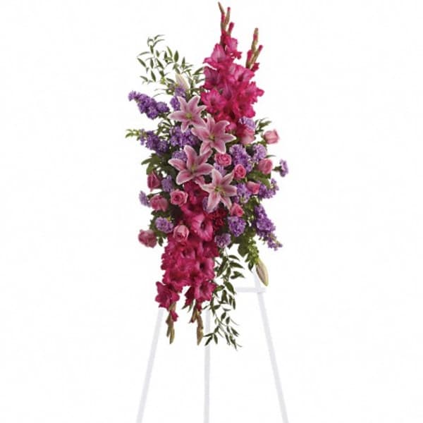 Tall pink and purple floral spray on a white stand