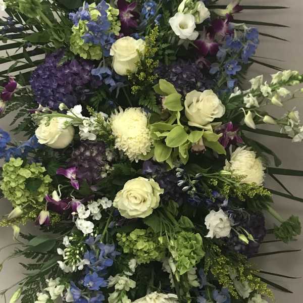 Large standing spray with white roses, blue flowers, and purple orchids
