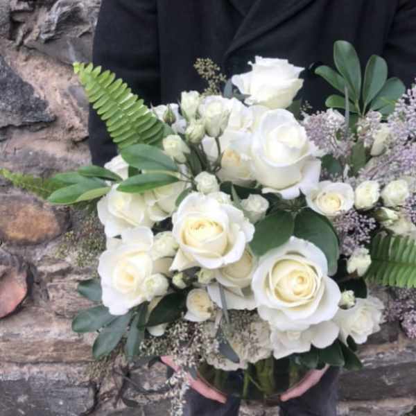 Bouquet of white roses with greenery and lavender filler