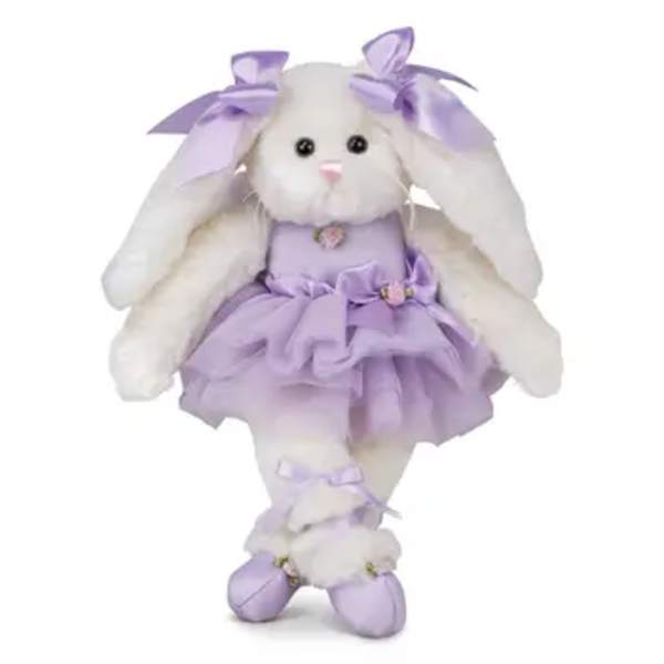 White plush bunny doll in a lavender dress with bows