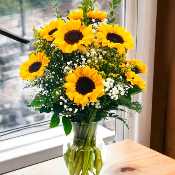 Sunflower bouquet in a clear glass vase on a table