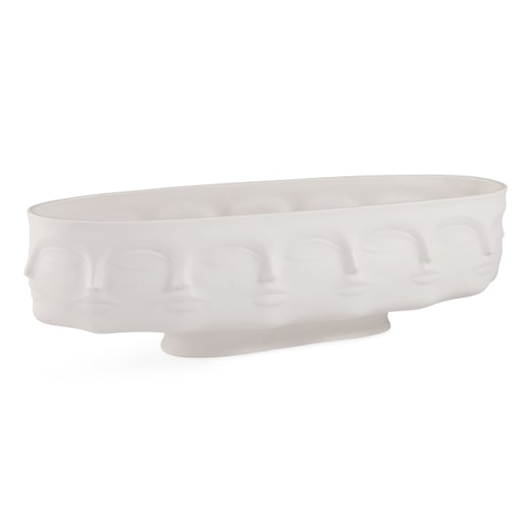 White oval ceramic planter with embossed face motifs