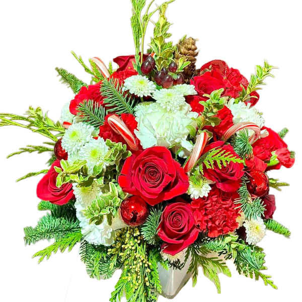 Red roses and white flowers in a vase with pine and ornaments