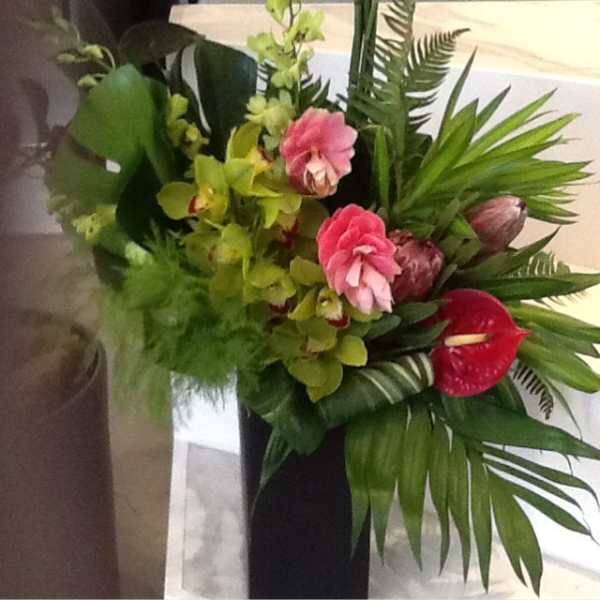 Tropical bouquet with pink orchids and a red anthurium