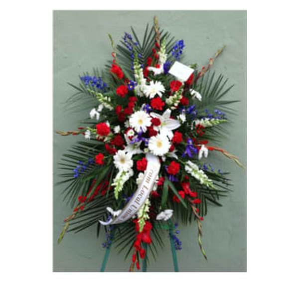 Standing funeral spray with red, white, and blue flowers