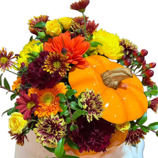 Fall bouquet with a pumpkin and mixed orange, yellow, and burgundy flowers