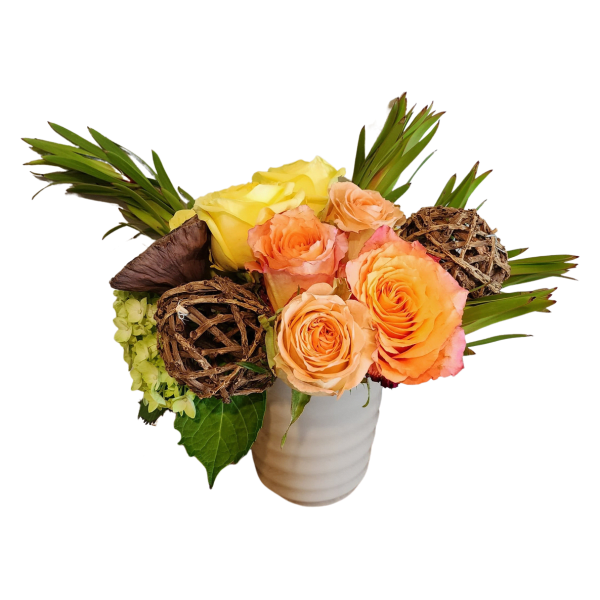 Bouquet of peach and yellow roses in a white vase