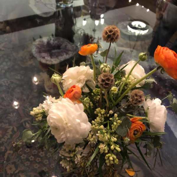 Mixed bouquet with white and orange blooms in a vase
