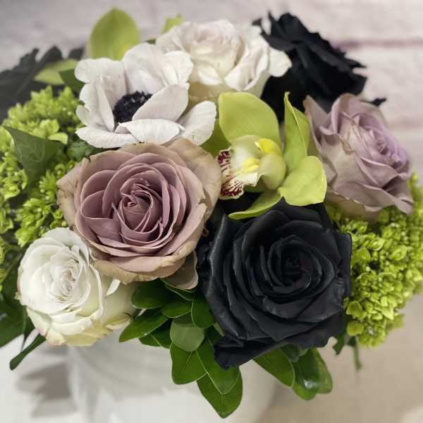 Bouquet of roses and orchids with bright green filler