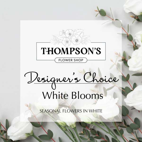 White floral shop sign with eucalyptus and white blooms
