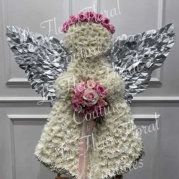 Angel-shaped floral arrangement with pink roses and silver wings