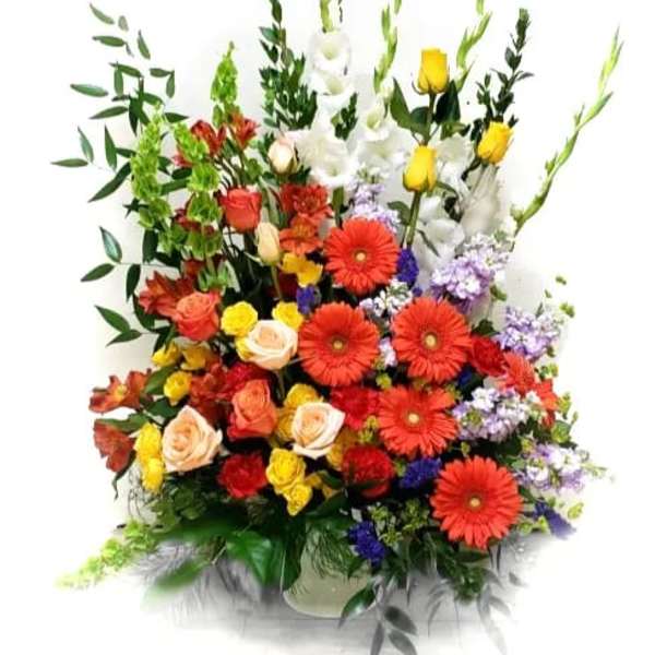 Tall mixed bouquet with red gerberas, roses, and white lilies