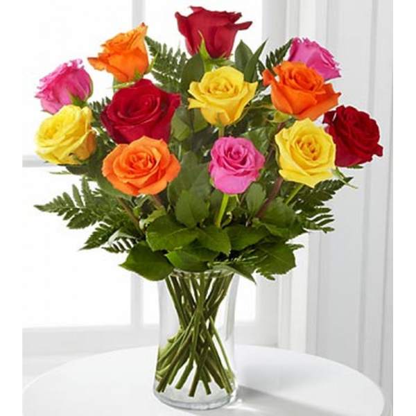 Mixed-color roses in a clear glass vase