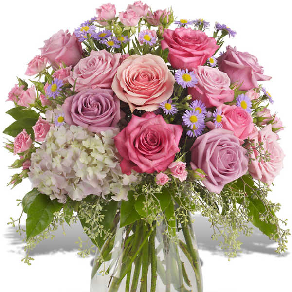 Pink and lavender roses with small purple daisies in a glass vase
