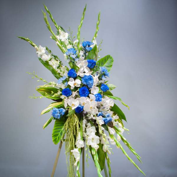 Tall blue and white floral spray on a stand