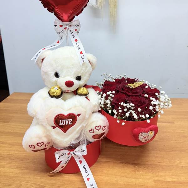 Teddy bear gift with a red heart balloon and a box of red roses