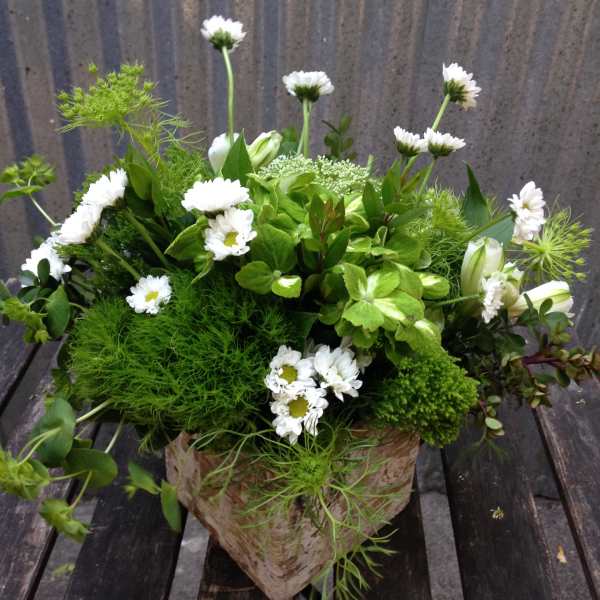 White daisy bouquet in a rustic paper-wrapped container