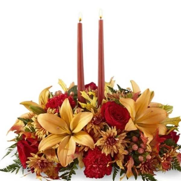 Autumn floral centerpiece with two red taper candles