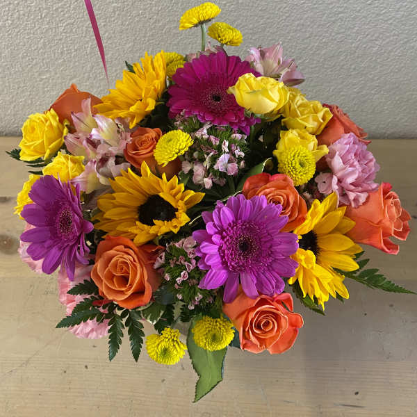 Colorful bouquet of roses, gerbera daisies, and sunflowers