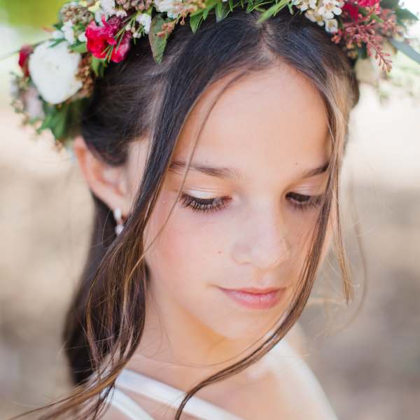Girl wearing a floral crown with white and pink flowers