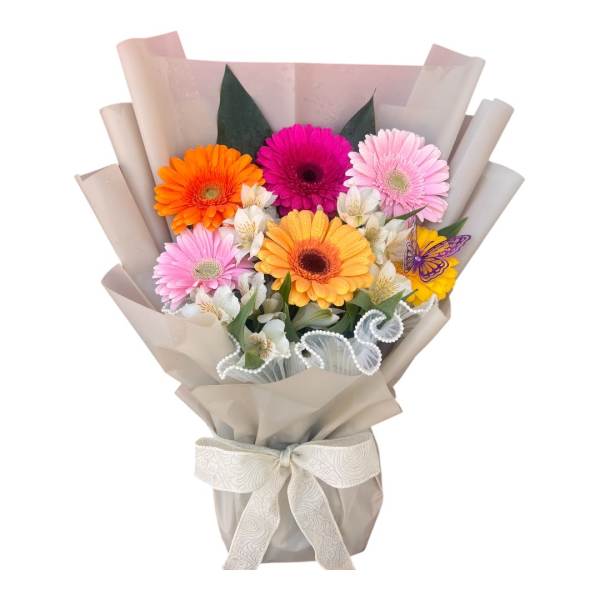Bouquet of colorful gerbera daisies wrapped in beige paper with a ribbon