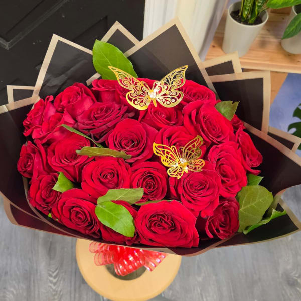 Bouquet of red roses with decorative butterfly picks