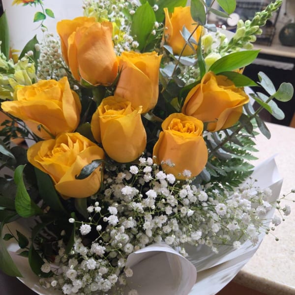 Bouquet of yellow roses with white baby's breath and greenery