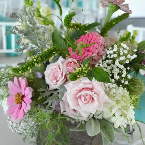 Mixed pink and white flowers in a square wooden container